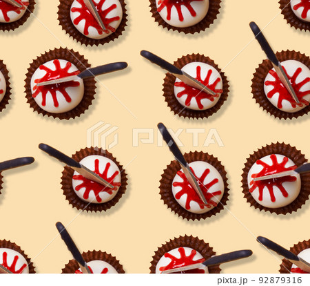 Seamless pattern of Halloween treat desserts decorated knifes. Seamless pattern of Halloween treat desserts decorated knifes. 92879316