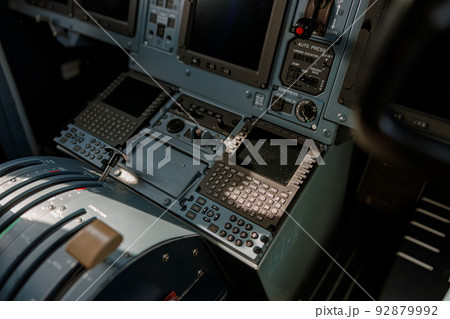 Airplane cockpit with flight displays, switches and knobs 92879992