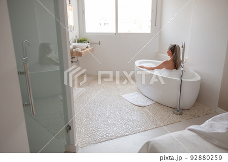 Beautiful adult lady taking bath in spa 92880259