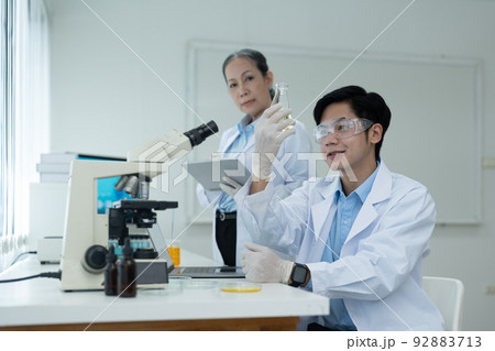 Science Oil Chemistry Expertise is Experiment Analysis With Microscope Equipment in Laboratory. Double Exposure of Scientist Chemical Research Testing and Study Oil Lubricant in Lab. Oil Industry. 92883713