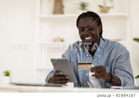 E-Commerce Concept. Smiling Black Man Using Digital Tablet And Credit Card 92884187
