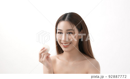 Beauty concept of 4k Resolution. Asian girls rub their cheeks with powder foundation. 92887772