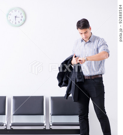 Man nervously impatiently waiting in the lobby Man nervously impatiently waiting in the lobby 92888584