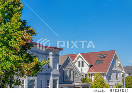 House peaks exterior against the blue sky in San Francisco, CA 92888812