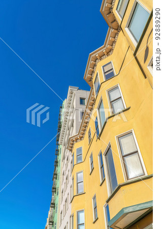 Low angle view of a residential building with yellow stucco wall in San Francisco, CA Low angle view of a residential building with yellow stucco wall in San Francisco, CA 92889290