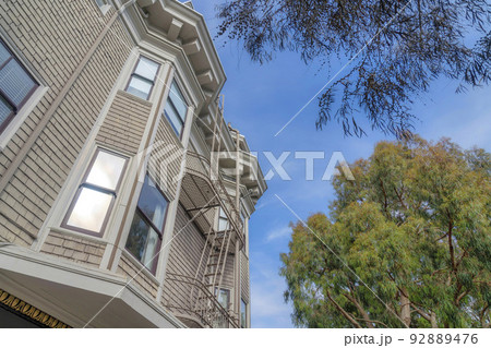 Apartment building in a low angle view with wood shingles sidings in San Francisco, California Apartment building in a low angle view with wood shingles sidings in San Francisco, California 92889476