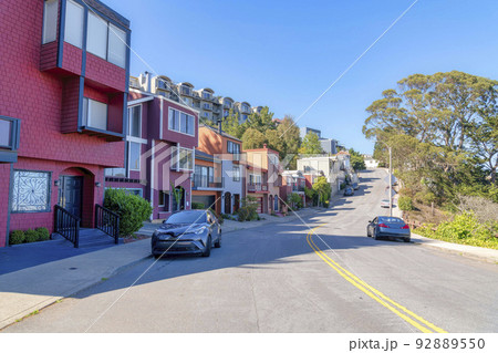 Road with double yellow lane near the row of suburban houses in San Francisco, California 92889550