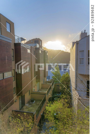 High angle view of multi-storey townhouses with a view of a mountain at the back against the sunset 92889682