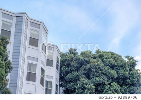 Townhouse exterior with bay windows and trees outdoors in San Francisco, California 92889706