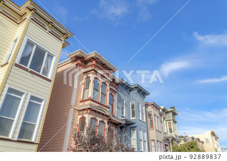 Low angle view of townhouses with colorful wood sidings in San Francisco, California 92889837