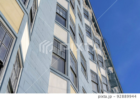 Low angle view of a multi-storey apartment in San Francisco, CA with blue, beige, and white exterior Low angle view of a multi-storey apartment in San Francisco, CA with blue, beige, and white exterior 92889944