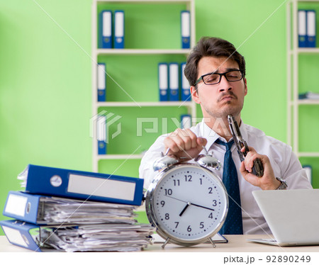 Despaired businessman thinking of suicide in the office Despaired businessman thinking of suicide in the office 92890249