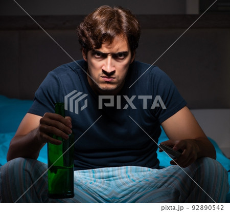 The man drinking in the bed under stress The man drinking in the bed under stress 92890542