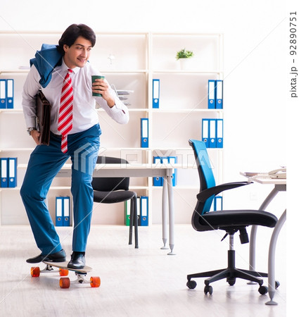 Young handsome businessman with longboard in the office 92890751