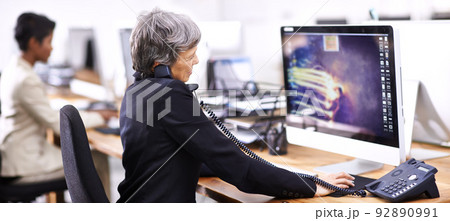 Just another busy day in the office. Cropped shot of two businesswomen working in an office. 92890991