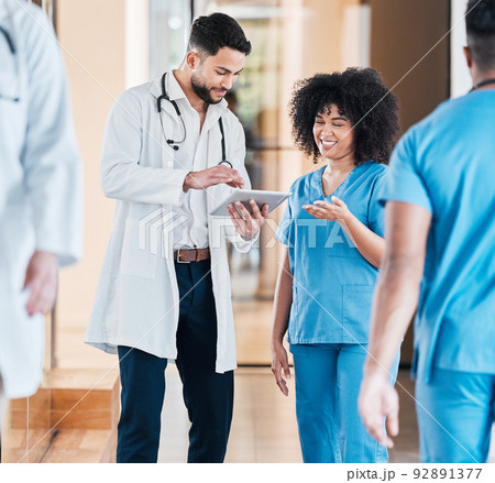 Digital diagnosis is faster diagnosis. Shot of two young doctors using a tablet and having a discussion in a modern office. Digital diagnosis is faster diagnosis. Shot of two young doctors using a tablet and having a discussion in a modern office. 92891377