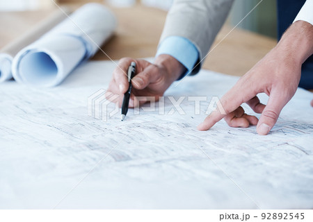 Ready to build their empire. Close up of architects going over the building plans. 92892545