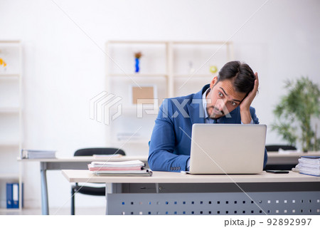 Young male employee working in the office 92892997