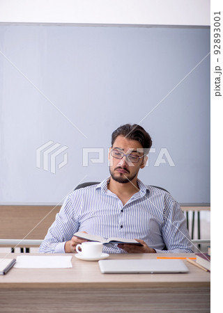 Young male teacher in the classroom Young male teacher in the classroom 92893001
