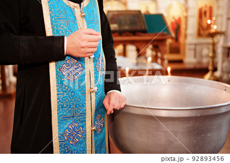 priest with orthodox cross on baptism in Orthodox Church. 92893456