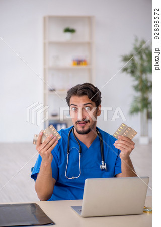 Young male doctor working in the clinic Young male doctor working in the clinic 92893572
