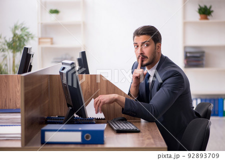 Young male employee in industrial espionage concept Young male employee in industrial espionage concept 92893709