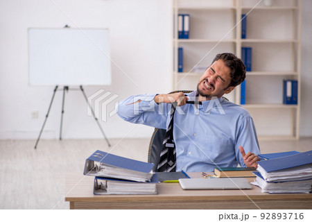 Young male employee working in the office 92893716