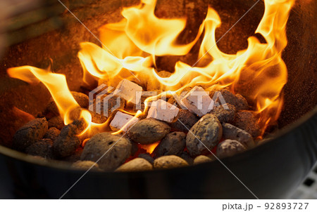 Fireside fun. Closeup of a warm fire burning in a barbeque. Fireside fun. Closeup of a warm fire burning in a barbeque. 92893727
