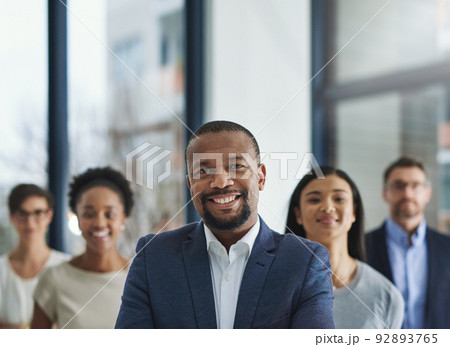 Positive leaders create productive teams. Cropped shot of a group of businesspeople standing in the office. 92893765