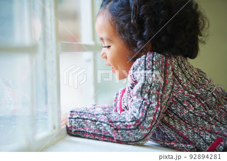 Learning as she grows. Shot of a cute little girl at home. 92894281