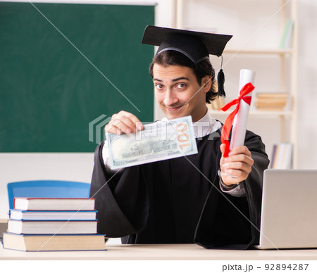 Graduate student in front of green board 92894287