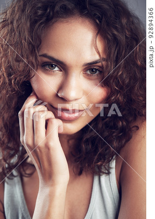 Beauty personified. Studio shot of a gorgeous young woman posing against a gray background. Beauty personified. Studio shot of a gorgeous young woman posing against a gray background. 92894366