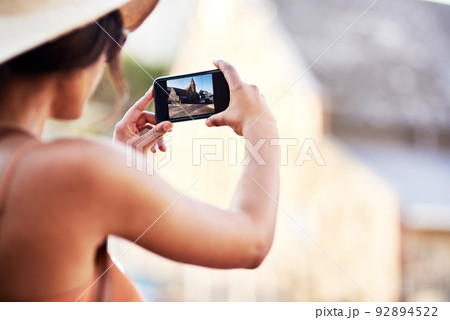 Capturing all the beauty of this wonderful city. Rearview shot of an unrecognizable young woman taking photos in a foreign city. Capturing all the beauty of this wonderful city. Rearview shot of an unrecognizable young woman taking photos in a foreign city. 92894522