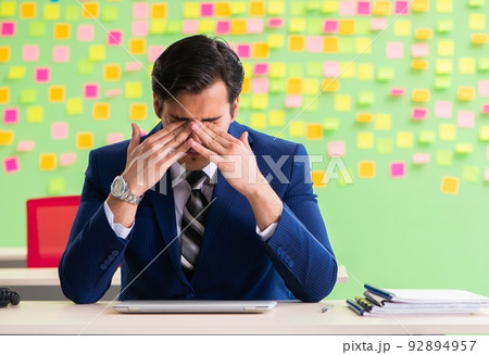 Businessman with many conflicting priorities Businessman with many conflicting priorities 92894957