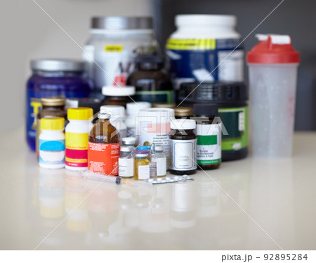 Feeding the addiction. Medicine bottles and pills with protein shakes and meal replacements. Feeding the addiction. Medicine bottles and pills with protein shakes and meal replacements. 92895284