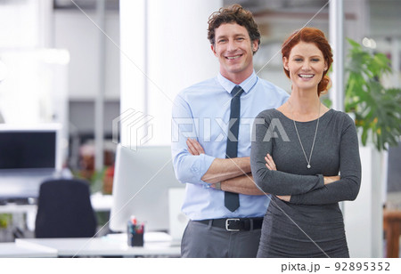 They make a great business team. Cropped shot of two colleagues standing in an office. They make a great business team. Cropped shot of two colleagues standing in an office. 92895352