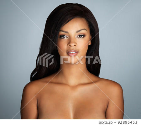 Studio portrait of a beautiful young woman with flawless skin posing against a gray background Studio portrait of a beautiful young woman with flawless skin posing against a gray background 92895453