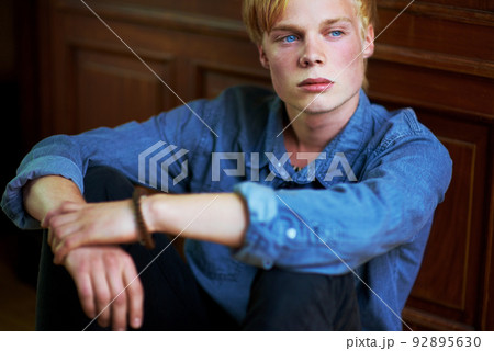 Brooding youth. Thoughtful and handsome young blonde guy with very blue eyes. Brooding youth. Thoughtful and handsome young blonde guy with very blue eyes. 92895630