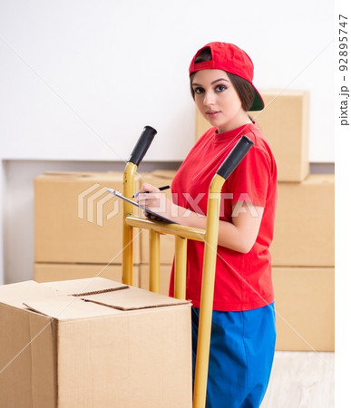 Young female professional mover doing home relocation Young female professional mover doing home relocation 92895747