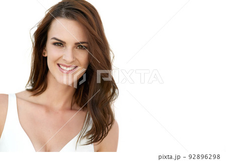 Nothing makes me more beautiful than believing I am. Studio portrait of an attractive young woman posing against a white background. 92896298