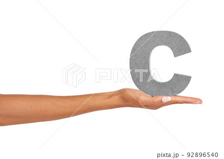 C what I did there.... A young woman holding a capital letter C isolated on a white background. 92896540