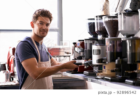 You name the blend and hell make it. Portrait of a young male barista in a coffee shop. 92896542