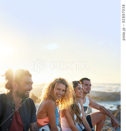 group of friends on beach enjoying summer holiday students having fun vacation hanging out on beachfront at sunset group of friends on beach enjoying summer holiday students having fun vacation hanging out on beachfront at sunset 92897038