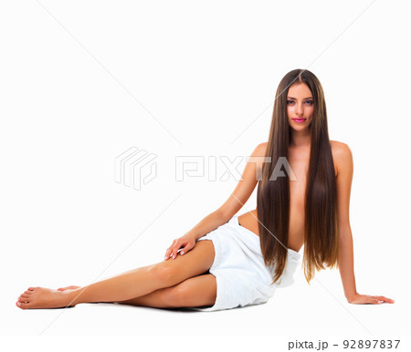 Like a modern day mermaid. Studio portrait of a young woman with long silky hair against a white background. Like a modern day mermaid. Studio portrait of a young woman with long silky hair against a white background. 92897837