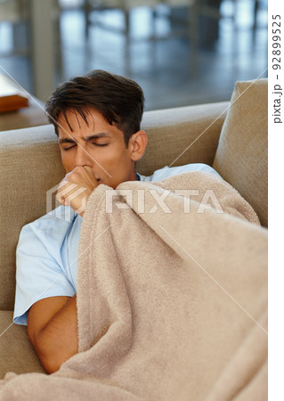 No more staying out late for me. Cropped shot of a young man coughing. No more staying out late for me. Cropped shot of a young man coughing. 92899525