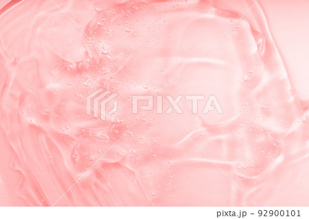 Beauty hyaluronic acid spread. Cosmetic jelly serum texture. Clear collagen gel, moisturizer backdrop. Pink liquid transparent skin care product sample. Emulsion Beauty hyaluronic acid spread. Cosmetic jelly serum texture. Clear collagen gel, moisturizer backdrop. Pink liquid transparent skin care product sample. Emulsion 92900101