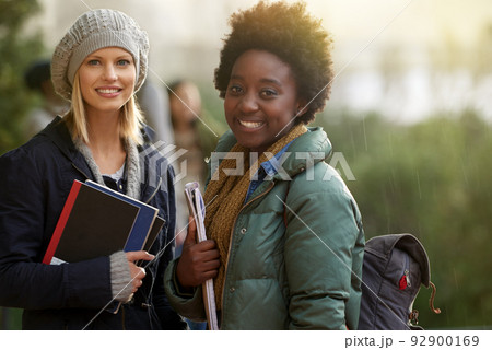 Were on our way to class. Cropped portrait of two college students on campus. 92900169