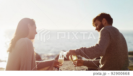 Non one plans a date better than he does. Rearview shot of a young couple having a picnic on the beach. 92900668