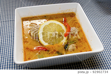 Closeup of healthy cooked meal with lemon chicken curry, red pepper vegetables served in bowl at restaurant or home. Delicious and gourmet homemade lunch or dinner. Diet food for nutrition 92902734