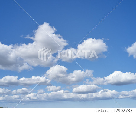 A cloudy sky on a quiet, peaceful morning with copy space. Relaxing view of a soothing sunny day with details of cloudy shapes and patterns. Beautiful cloudscape view of fluffy clouds in a blue sky 92902738